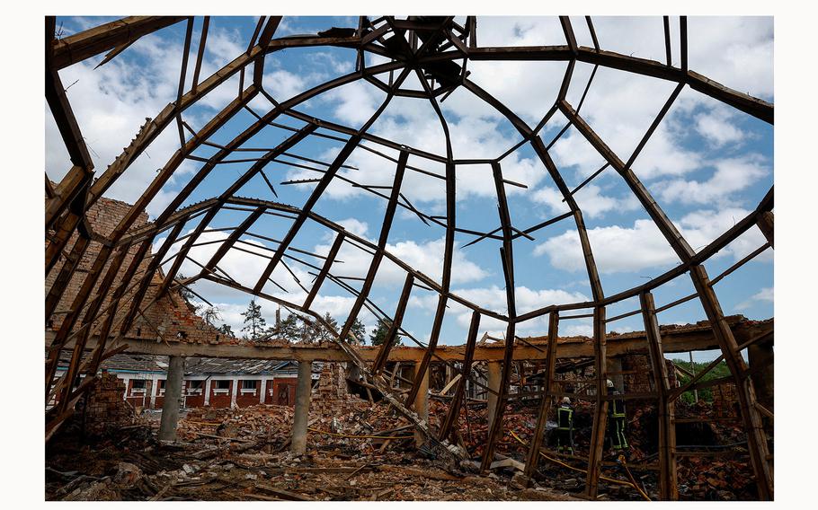 Firefighters arrive at the site of a school damaged by Russian missile strikes, outside Kharkiv, Ukraine, on May 30, 2024.