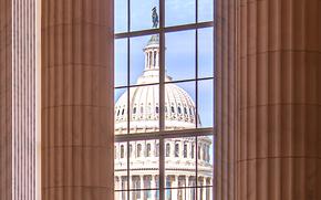 The U.S. Capitol seen through a window of the Cannon House Office Building.