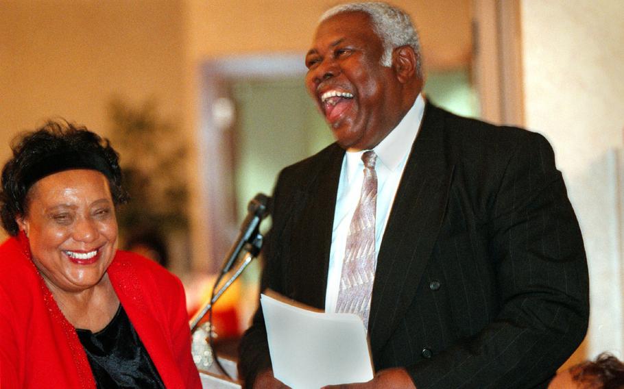 Residents of Burns Street SE celebrate 20 years of a neighborhood watch in 1999. Party organizer Elaine Bowman, left, shares a laugh with her husband, Bertie Bowman.