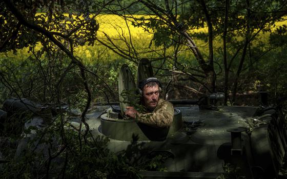 A Ukrainian soldier from the 57th Brigade waits for an order for his artillery vehicle to open fire on Russian positions at the front line in Ukraine’s Kharkiv region, Sunday, May 19, 2024. (AP Photo/Evgeniy Maloletka)
 