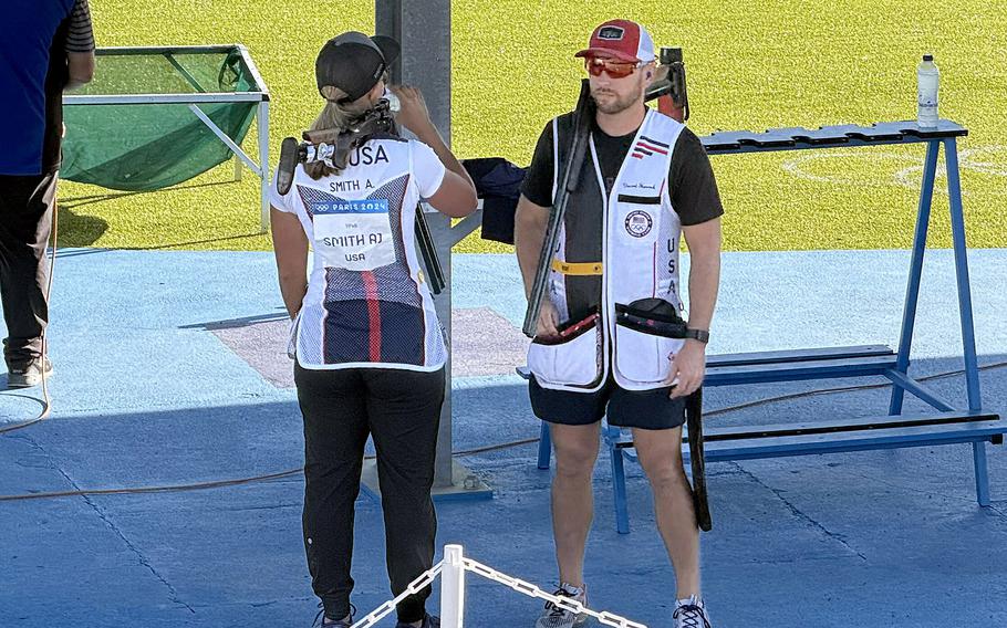 Army veteran Vincent Hancock looks on as American teammate Austen Smith takes a sip of a drink during the first round of the skeet mixed team qualification on Monday, Aug. 5, 2024, at the Chateauroux Shooting Centre in Chateauroux, France.