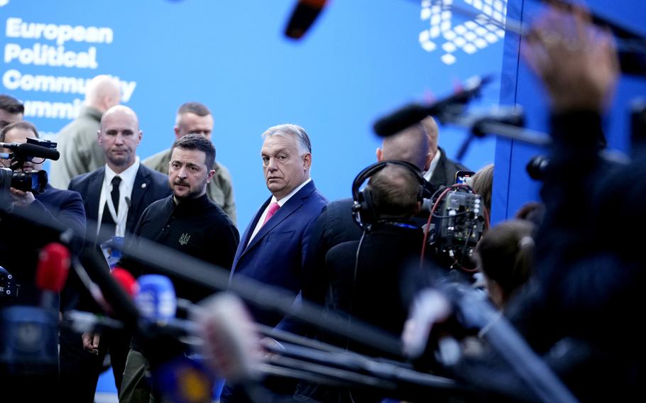 Ukraine’s President Volodymyr Zelenskyy, center left, speaks with Hungary’s Prime Minister Viktor Orban, center right, as he arrives for the European Political Community (EPC) Summit at the Puskas Arena in Budapest, Hungary, Thursday, Nov. 7, 2024. 