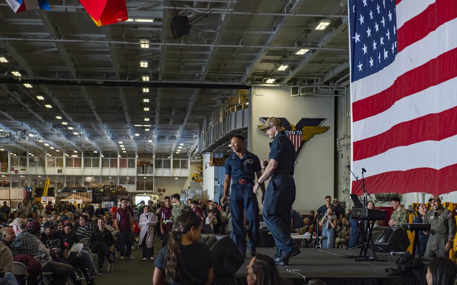 Aviation Ordnanceman 2nd Class Randolph Reed of Carson, Calif., and Gunner’s Mate 2nd Class Dustin Mason of Douglas, Ariz., perform in the hangar bay aboard USS Carl Vinson while underway for a Family and Friends Day Cruise on Saturday, Aug. 17, 2024. 