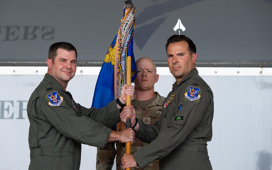 U.S. Air Force Col. Paul Sheets, left, 23rd Wing commander, presents the 23rd Fighter Group guidon to Col. Nicholas DiCapua, 23rd FG commander, during a change of command ceremony, July 21, 2023, at Moody Air Force Base, Ga. 