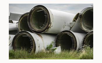 A pile of wind turbine parts is piled up along almost the entire west border of Darcy Richarson’s property in Grand Meadow, Minnesota on Aug. 7, 2024. Richardson worries about children getting hurt and rodents and animals nesting in the large empty cavities. 