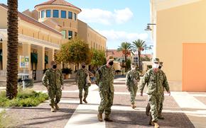 Rear Adm. Scott Gray, commander of Navy Region Europe, Africa, Central, front right, walks through Midtown at Naval Air Station Sigonella in Sicily during a familiarization tour on Oct. 28, 2020. Some Defense Department civilian employees received contradictory emails from a NAVEURAFCENT human resources director about their eligibility for a buyout offered to federal workers this week by the White House.