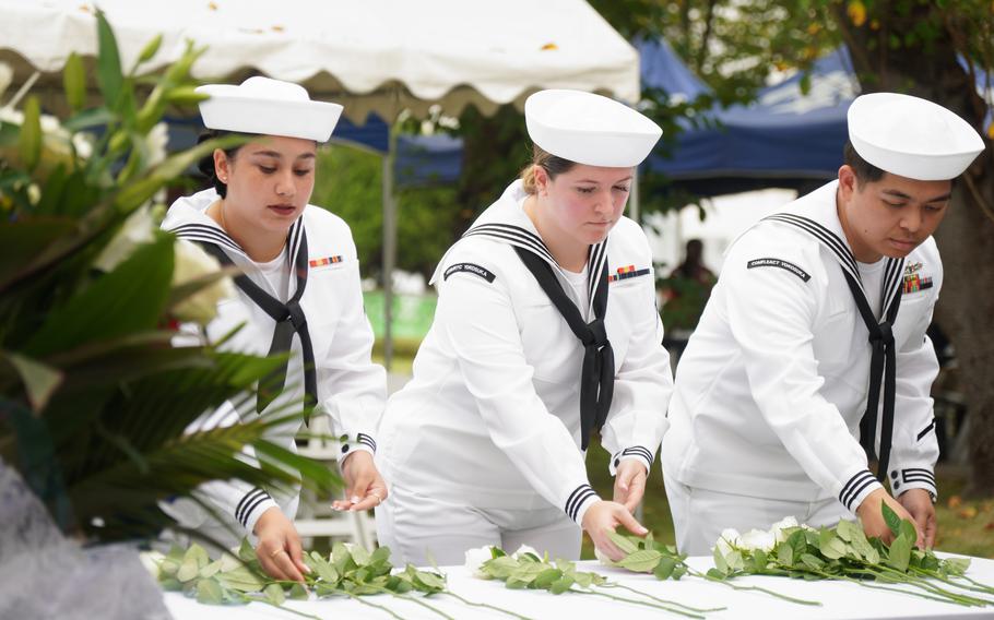 Sailors lay flowers in memory of deceased service members during the Bells Across America ceremony at Yokosuka Naval Base, Japan, Thursday, Sept. 19, 2024.