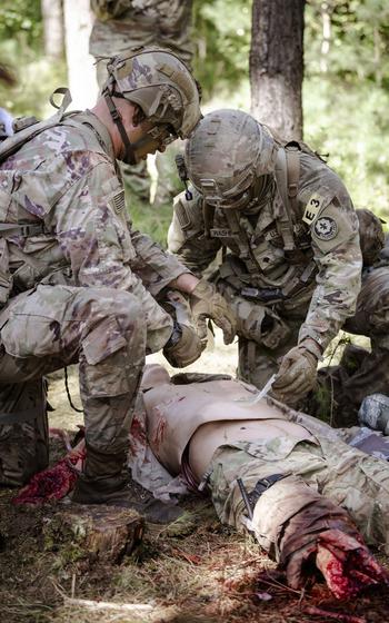 U.S. soldiers with 2nd Cavalry Regiment simulate tactical combat casualty care Aug. 6, 2024, during an event at U.S. Army Europe and Africa’s Best Squad Competition at Grafenwoehr Training Area in Germany.