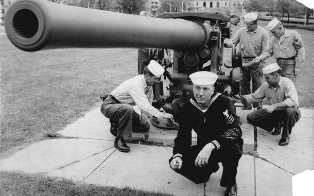 Members of the U.S. Naval Reserve apply a fresh coat of paint to the gun that fired the first shot at Pearl Harbor. Mounted on the deck of the USS Ward, the 4-inch gun sank a Japanese mini-submarine lurking near the harbor's entrance on Dec. 7, 1941. Kneeling in the foreground is Boiler Technician Maurice J. Hurley, who was aboard the Ward that morning. (Neale Van Ness / Pioneer Press)