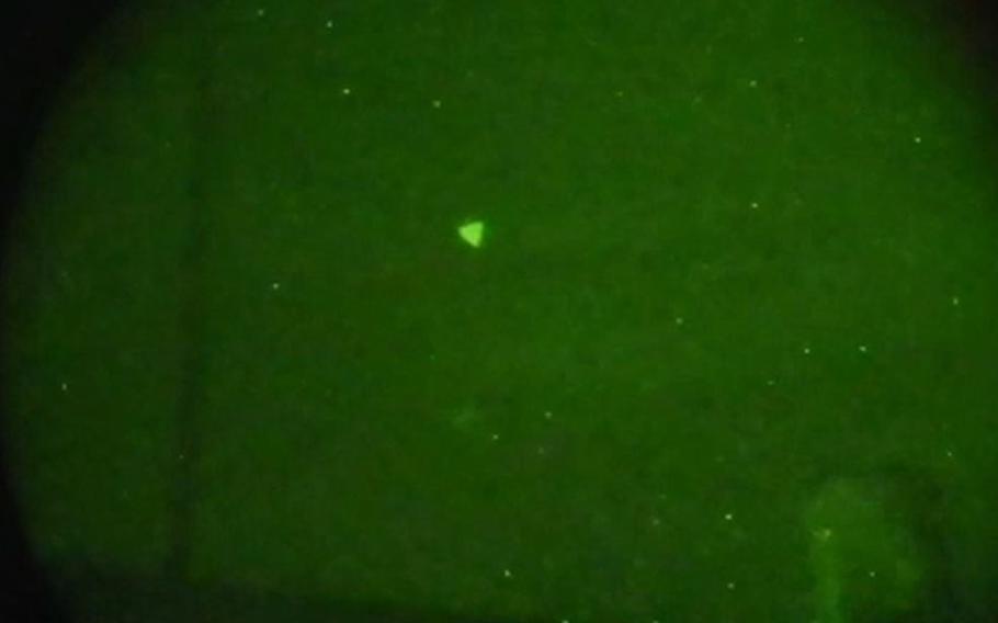 An unidentified object in the sky appears in a Navy image captured during a 2022 exercise off the east coast of the U.S. A recent inquiry by the Defense Department Inspector General found that the Pentagon lacks a coordinated approach to track and report UFOs.