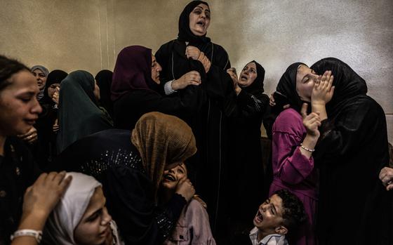 Family members gather to mourn around the body of 13-year-old Bana Laboum in the West Bank village of Qaryut on Saturday. Laboum's father and the Palestinian Health Ministry said she was shot and killed by Israeli forces on Friday. The military acknowledged opening fire and said the incident was “under review.” MUST CREDIT: Heidi Levine for The Washington Post