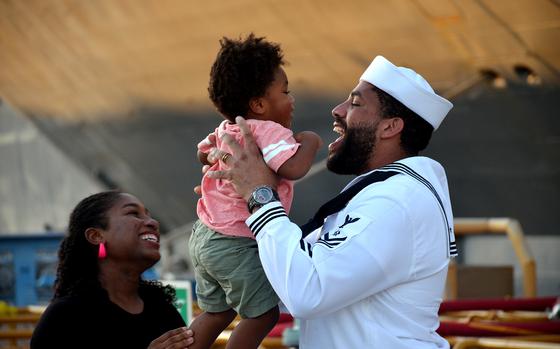 A USS Blue Ridge sailor greets his family just moments after stepping off the ship at Yokosuka Naval Base, Japan, Tuesday, Aug. 20, 2024. 