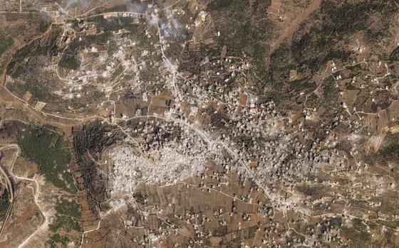 A satellite image of the Lebanese village of Aita al-Shaab, with a mass of gray indicating the rubble of destroyed buildings.