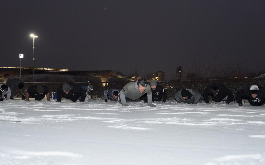 U.S. Defense Secretary Pete Hegseth does pushups with troops.