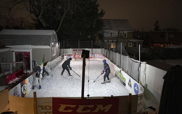 People skate on a backyard ice rink in Philadelphia. 