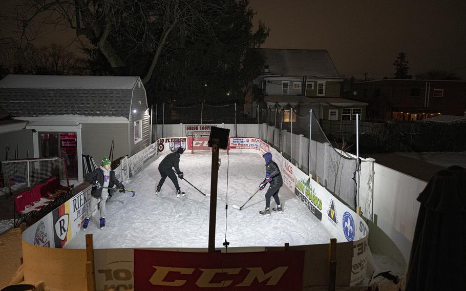 People skate on a backyard ice rink in Philadephia. 