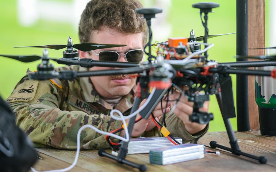 Army Sgt. Nicholas Murphy of the 3rd Infantry Division’s Combat Aviation Brigade tinkers with a hexacopter drone that he built on July 26, 2024, just before a test flight at a Hinesville, Ga., airfield just outside Fort Stewart. Murphy participated in a first-of-its-kind drone building class run by the division’s Marne Innovation Center at Fort Stewart. 