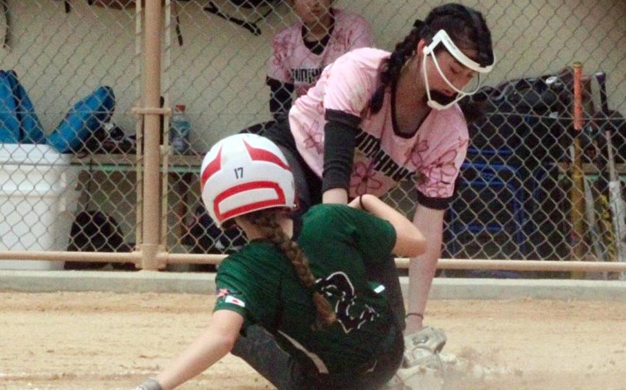 Kubasaki's Sarah Allen gets tagged out at home plate by Humphreys' Alexis Montalvo during Tuesday's Division I softball tournament game. The Dragons won 6-4.