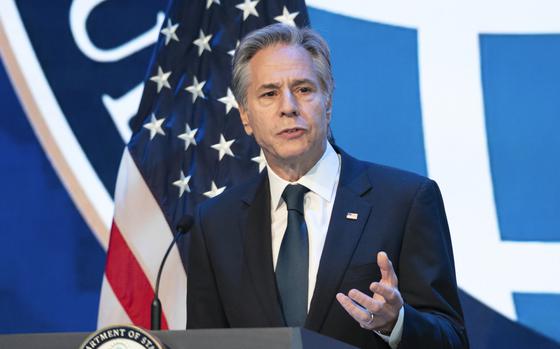 Secretary of State Antony Blinken speaking at a podium with one hand raised to gesture, Arlington, Va., Nov. 21, 2024.