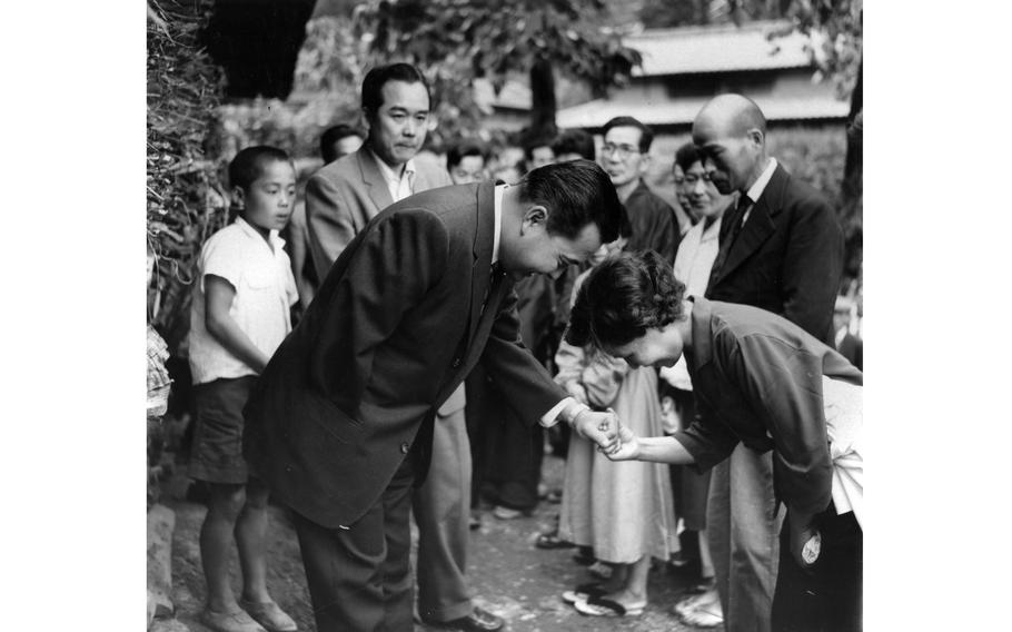 Rep. Daniel K. Inouye (D-Hawaii) greets one of the 400-some relatives in his ancestral village of Yokoyama, Japan. The Hawaiian congressman met many of the 2,200 villagers of Yokoyama — some 400 of whom are named Inouye.