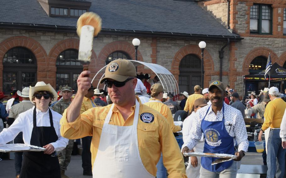 Lt. Cmdr. Christopher Bourque, the commanding officer of Navy Reserve Center Cheyenne, flips pancakes at a breakfast event on July 22, 2024.