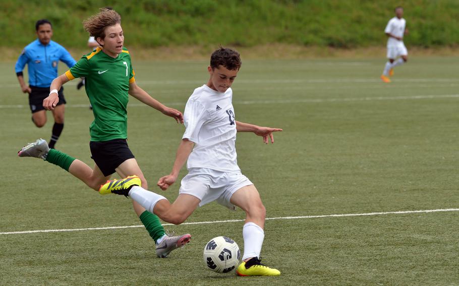 Ansbach’s Damien Abitua gets past Alconbury’s Anthony Sheehan for a shot on goal  in a Division III semifinal at the DODEA-Europe soccer finals in Landstuhl, Germany, May 22, 2024. Ansbach won the game 7-1 and will face AFNORTH in Thursday’s final.