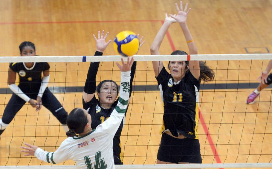 Kubasaki's Yuri Biggins spikes against Kadena's Christina Kehe and Leighton Botes during Tuesday's Okinawa girls volleyball match. The Panthers won in five sets.