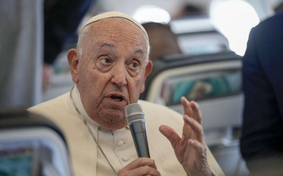 Pope Francis talks to journalists on the flight back to Rome at the end of his four-day visit to Belgium and Luxembourg, Sunday, Sept. 29, 2024.