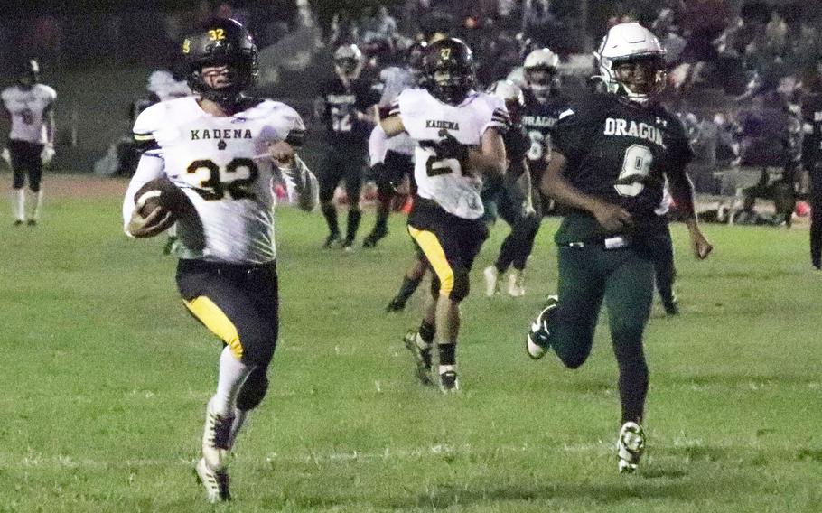 Kadena's Austin Lutz returns an interception for a touchdown against Kubasaki.