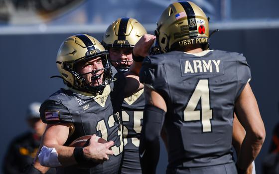 Army quarterback Bryson Daily, left, celebrates a touchdown during an NCAA college football game against East Carolina, Saturday, Oct. 19, 2024, in West Point, N.Y. (AP Photo/Eduardo Munoz Alvarez)