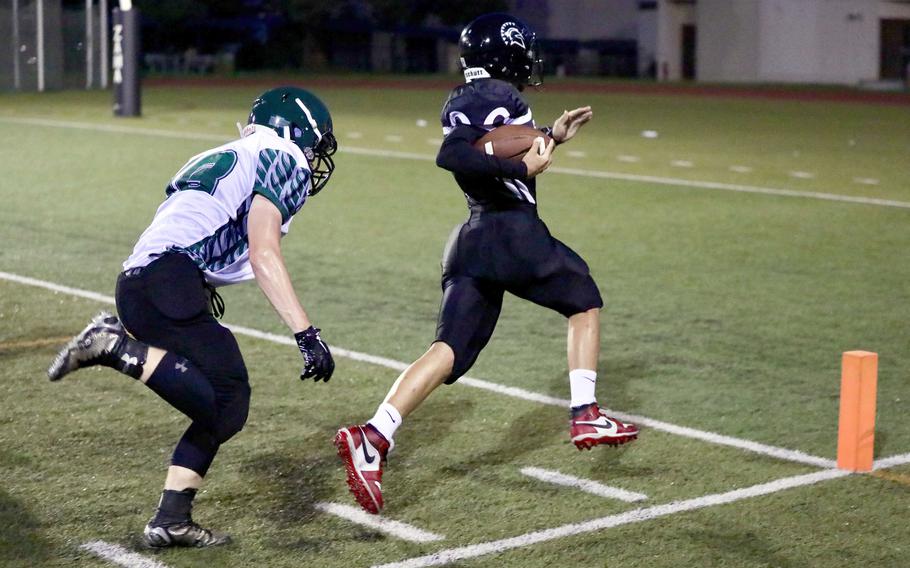 Zama's Roman Romero outraces Daegu defender Nathan Haws II to the end zone for the Trojans' first touchdown.