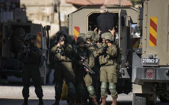 Israeli soldiers arrest a blindfolded Palestinian during an army raid in Tubas, West Bank, on Wednesday, Sept. 11, 2024. (AP Photo/Majdi Mohammed)