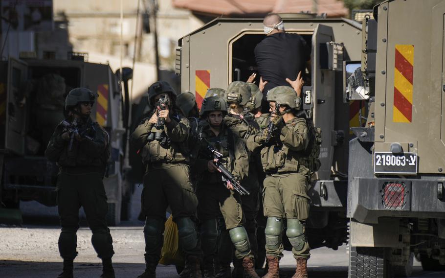 Israeli soldiers arrest a blindfolded Palestinian during an army raid in Tubas, West Bank, on Wednesday, Sept. 11, 2024.