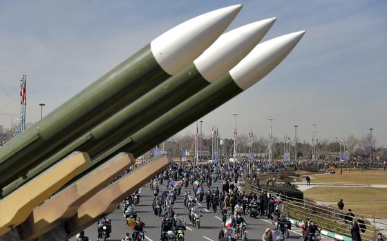 Iranians drive past missiles by their motorcycles during a rally marking the 42nd anniversary of the Islamic Revolution, at Azadi (Freedom) Square in Tehran, Iran, Wednesday, Feb. 10, 2021. As Iran threatens to attack Israel over the assassination of a Hamas leader in the Iranian capital, its long-vaunted missile program offers one of the few ways for Tehran to strike back directly, but questions loom over just how much of a danger it poses.