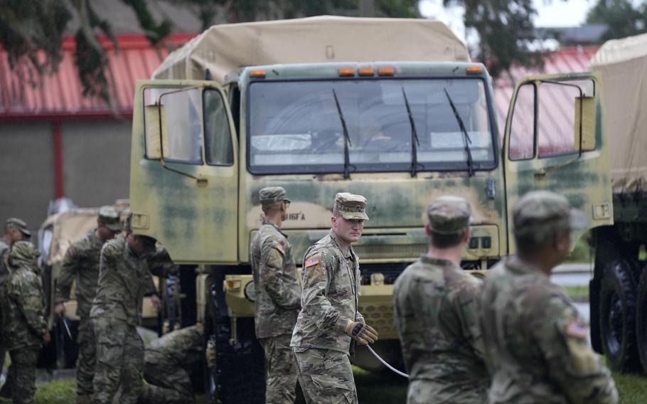 Members of the Florida National Guard prepare their equipment in Mayo, Fla., as they wait for instructions on where to respond, after the passage of Hurricane Idalia on Wednesday, Aug. 30, 2023. 