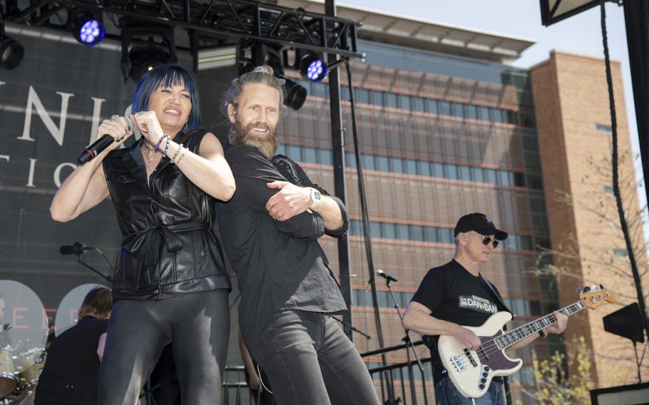 Molly Callinan and Jeff Vezain perform with Gary Sinise and the Lt. Dan Band on stage