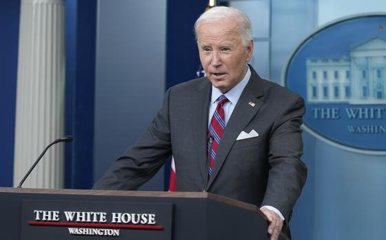 Joe Biden stands at a podium and speaks during a press briefing.