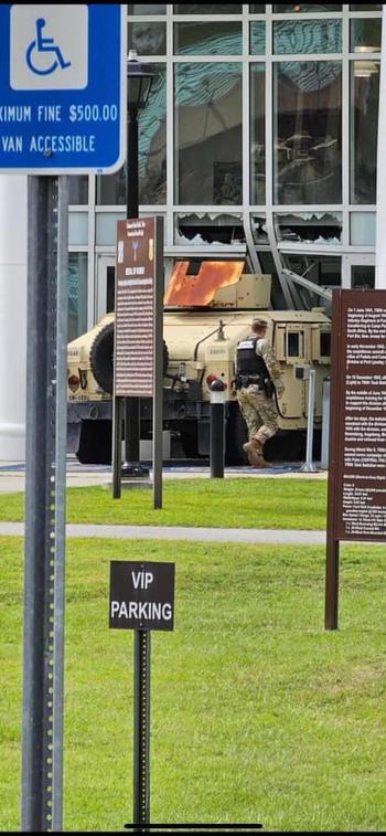 One person is in custody Monday after crashing a military vehicle into the front of the 3rd Infantry Division’s headquarters building at Fort Stewart, officials at the Georgia Army post said.