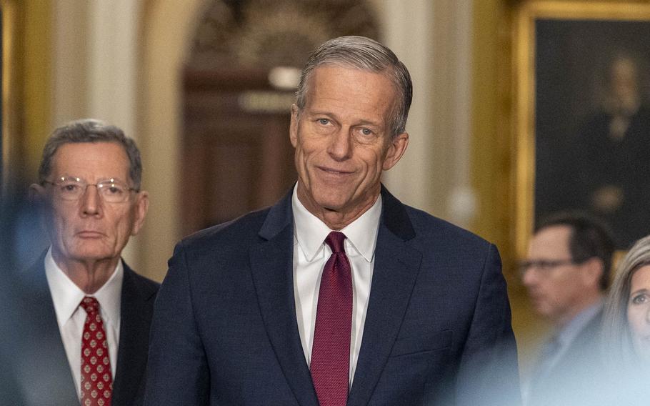 Sen. John Thune is seen from the chest up, tilting his head slightly and giving what looks like a small smile.