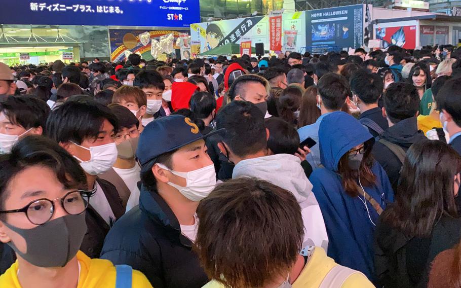 Revelers make their way across the iconic scramble crossing in Tokyo's Shibuya ward, Oct. 31, 2021.