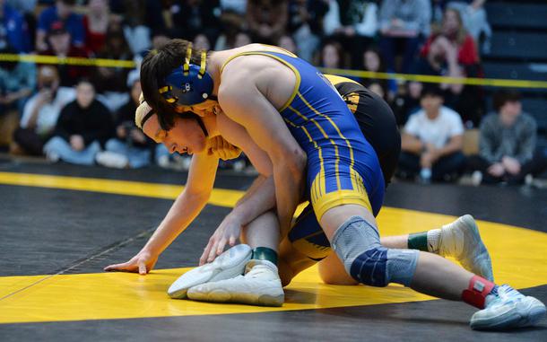 Munro Davis, right, beat Stuttgart’s Aidan Morgan to take the 132-pound title at the DODEA-Europe wrestling finals in Wiesbaden, Germany, Feb. 10, 2024.