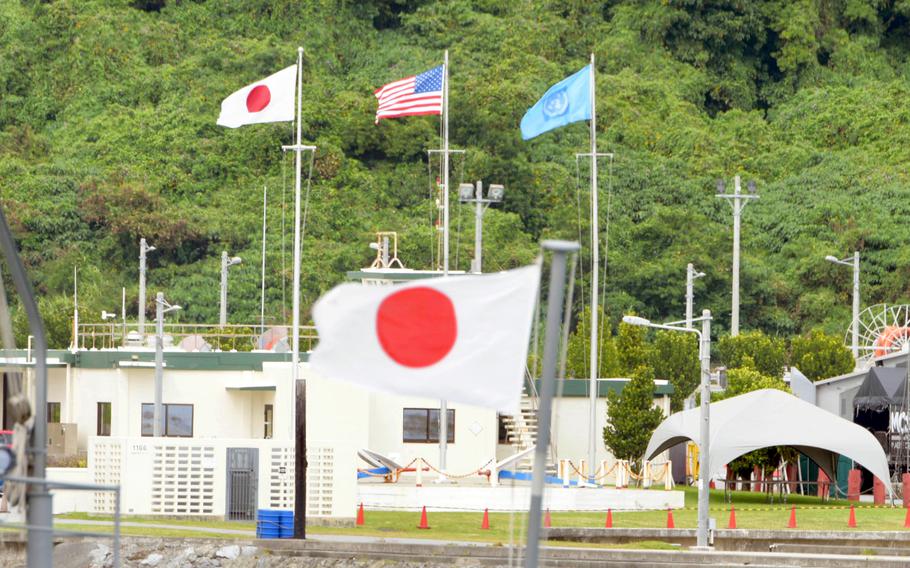 Japanese, American and United Nations flags flap in the breeze at White Beach Naval Facility, Okinawa, April 14, 2023. 
