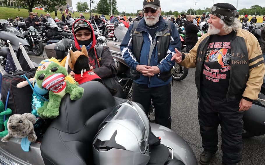 Sandy Haren, left, and her Navy veteran husband Rick, right, of Stafford, Va., talk with another rider in the RFK Stadium staging area before the Rolling to Remember ride, May 30, 2021 in Washington, D.C..