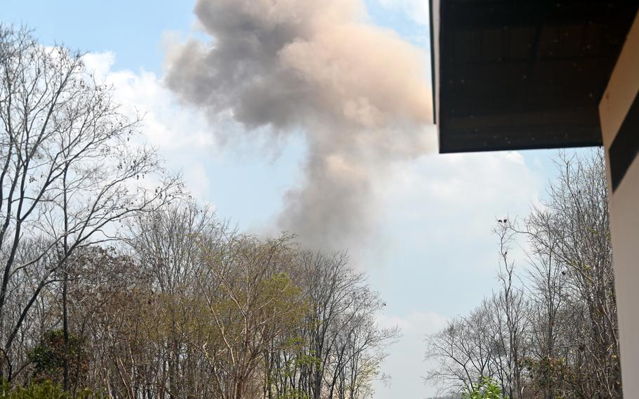 A plume of smoke rises as U.S. and Thai soldiers detonate more than 700 pounds of munitions.