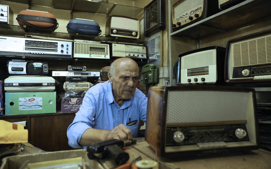 Reza Alimirzaei, 73, who repairs and sells old radios, works at his shop in downtown Tehran, Iran, Wednesday, Sept. 18, 2024.