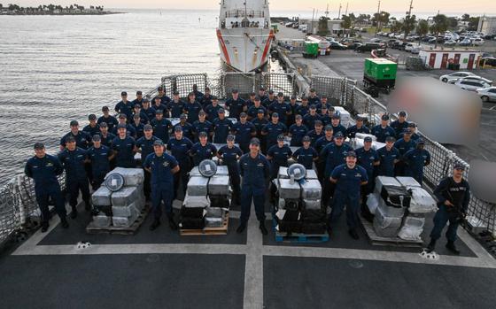 The crew of Coast Guard Cutter Resolute pose for a photo with the interdicted narcotics set to be unloaded onto Sector St. Petersburg South Moorings, Fla., Oct. 23, 2024. 