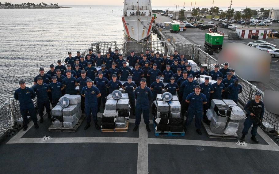 The crew of Coast Guard Cutter Resolute pose for a photo with the interdicted narcotics set to be unloaded onto Sector St. Petersburg South Moorings, Fla., Oct. 23, 2024. 