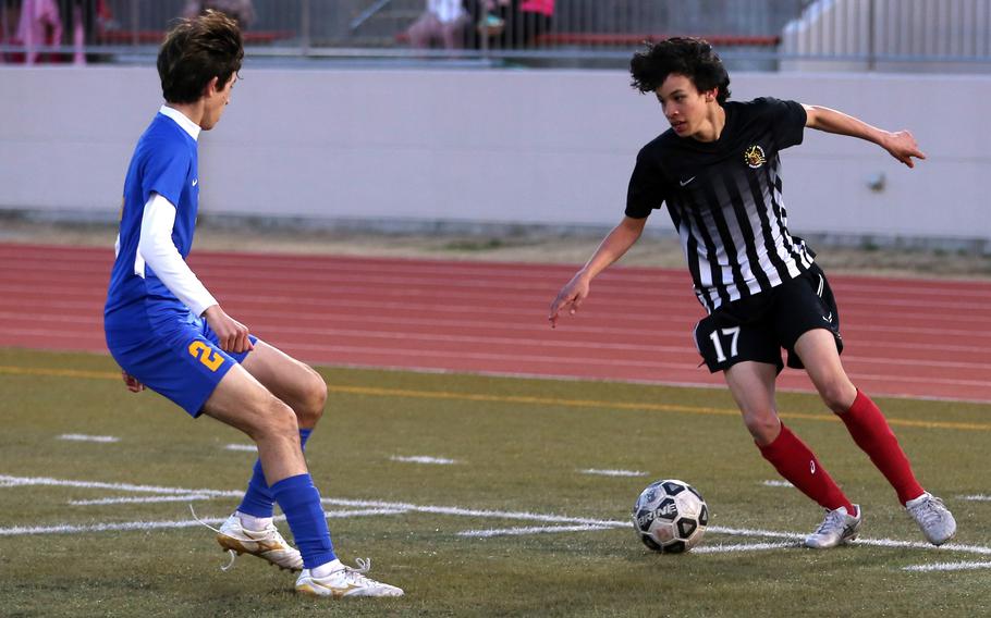 Matthew C. Perry's Cooper Allen tries to dribble against Yokota's Tommy Vogeley during Friday's DODEA-Japan boys soccer match. The Panthers won 4-1.