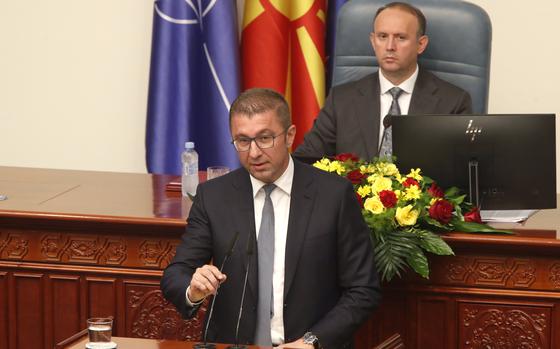 Hristijan Mickoski, the leader of the center-right VMRO-DPMNE party and prime minister-designate, speaks to lawmakers during a session in the parliament building in Skopje, North Macedonia, late Sunday, June 23, 2024. North Macedonia's parliament has approved a new conservative government late on Sunday proposed by a center-right party that won May's national elections. 