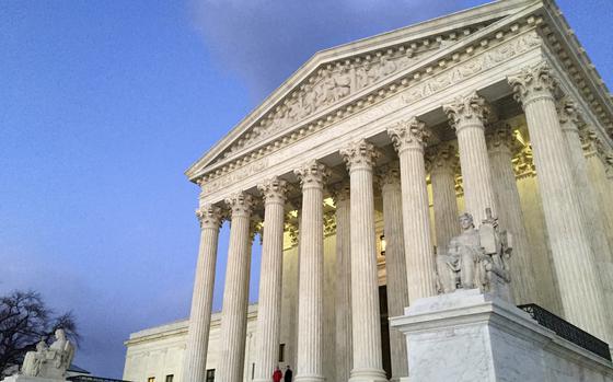 FILE - People stand on the steps of the Supreme Court at sunset in Washington, Feb. 13, 2016. (AP Photo/Jon Elswick, File)